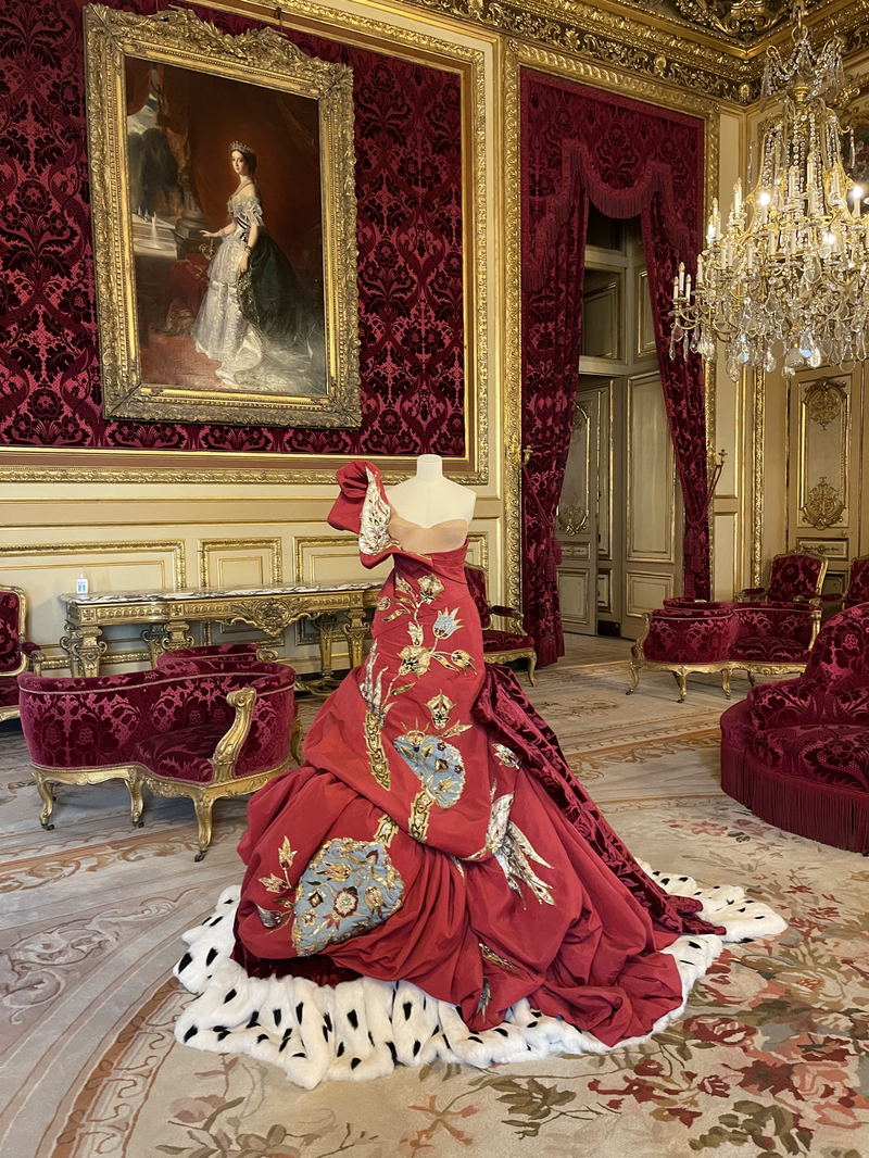A red couture dress at the Louvre